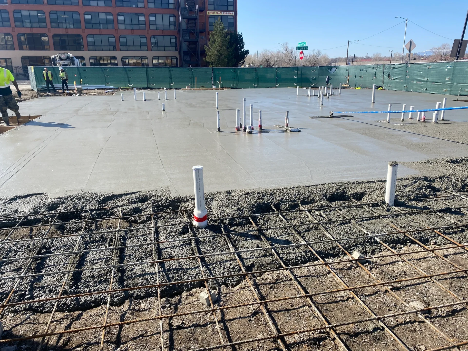 Large commercial concrete slab with rebar and plumbing sleeves poured in Colorado