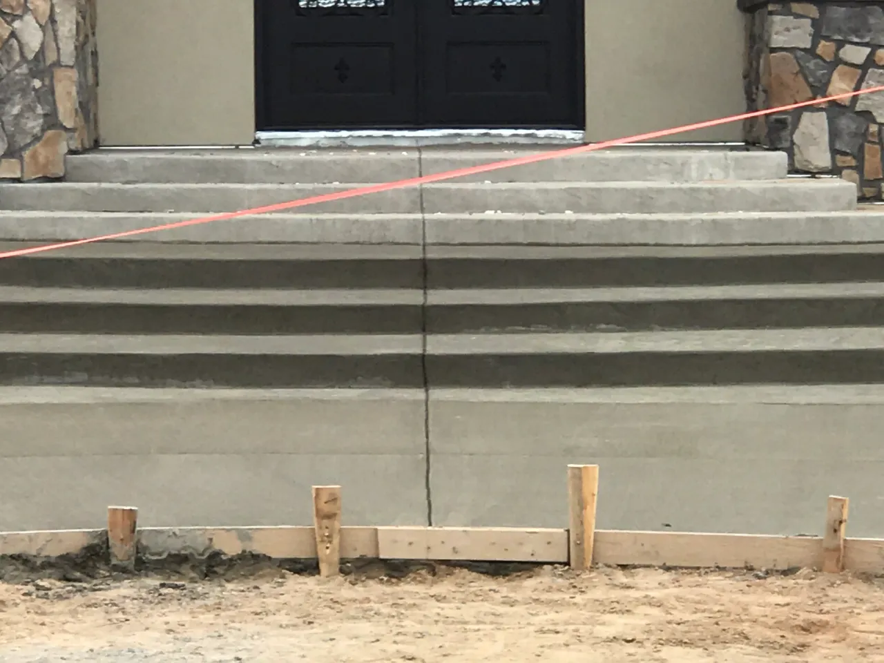 Broad concrete front entry steps with crisp formed risers at a new home in Falcon, CO