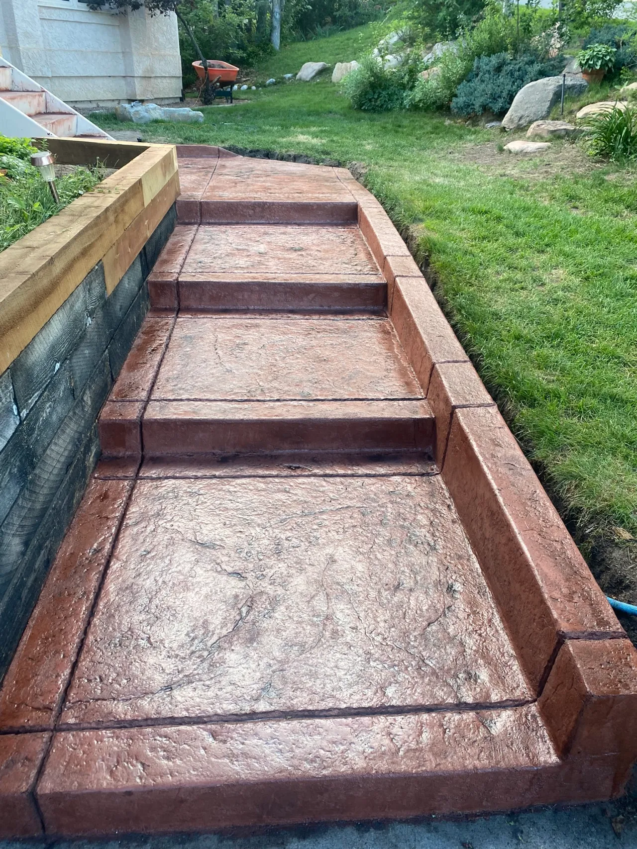 Red stamped concrete steps and landing with hand-tooled edges in Calhan, CO