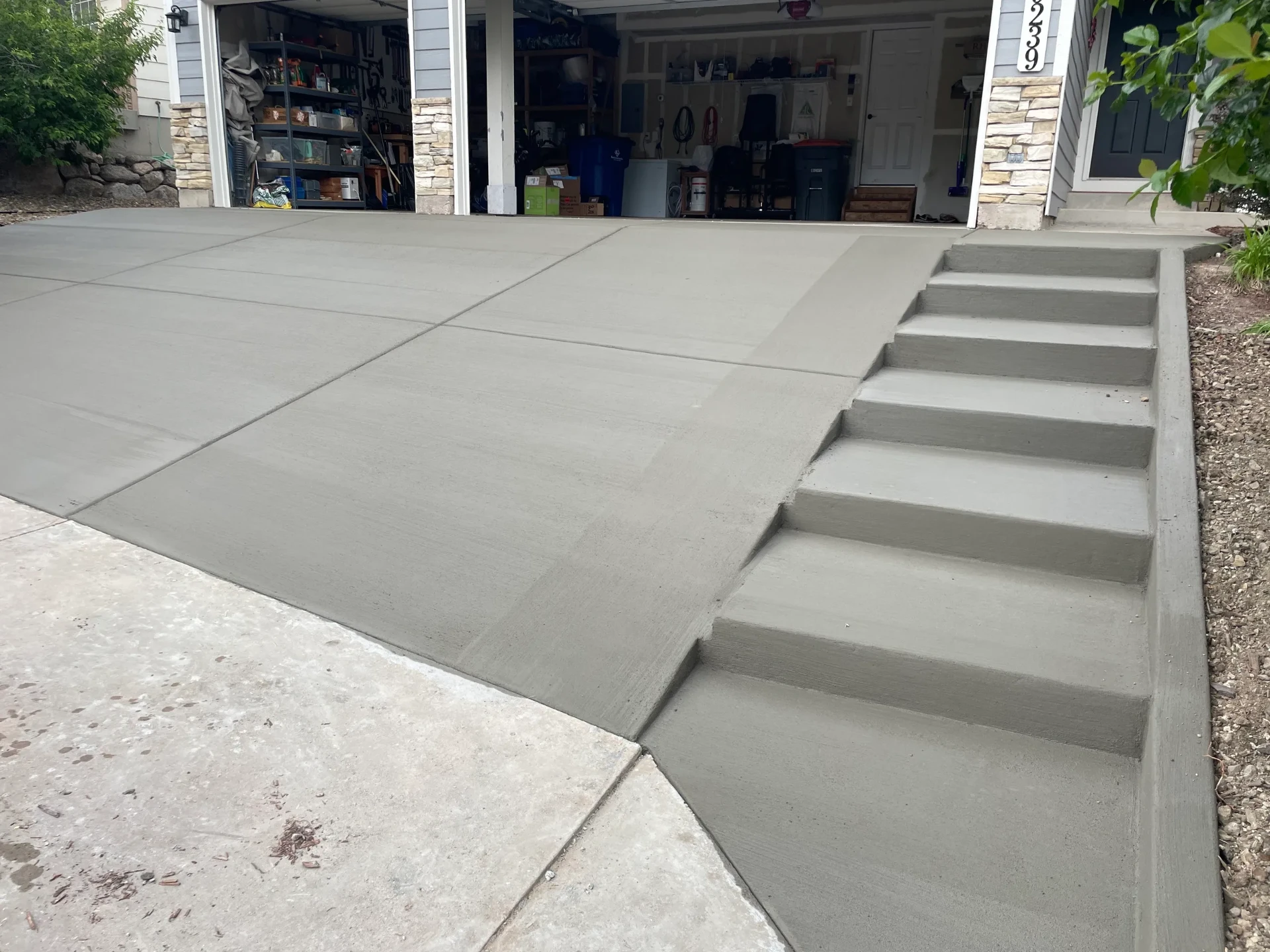 New concrete driveway and front entry steps at a two-car garage in Colorado Springs, CO