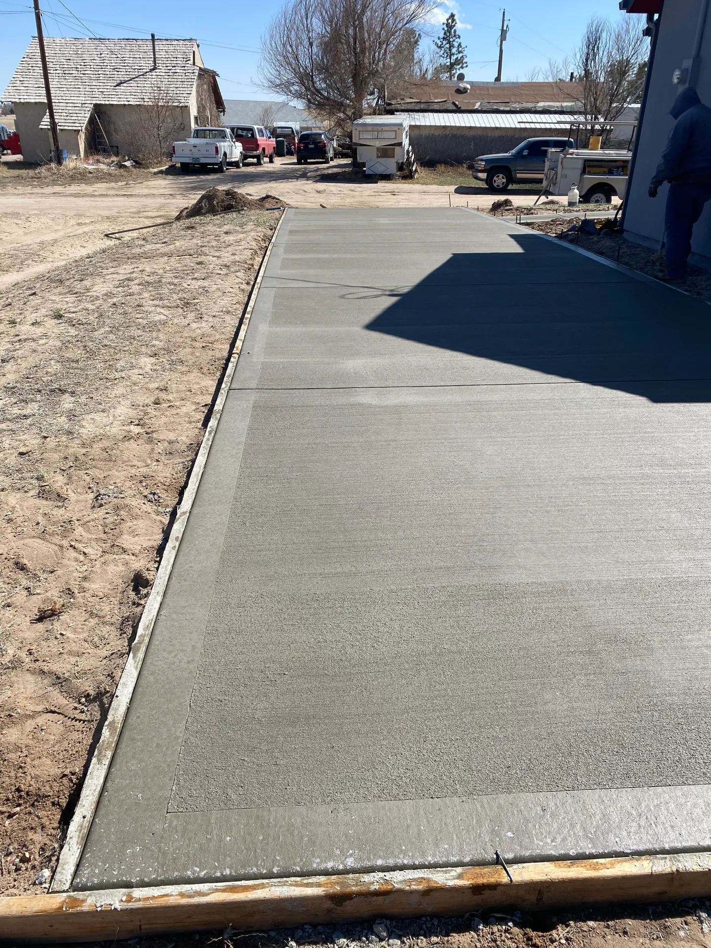 New concrete slab and approach beside a shop building on a rural Calhan, CO property